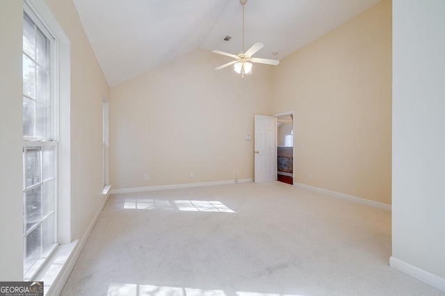 spare room featuring ceiling fan, light carpet, and lofted ceiling