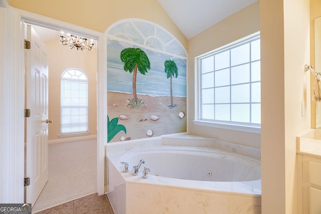 bathroom featuring lofted ceiling, tile patterned floors, vanity, a notable chandelier, and tiled bath