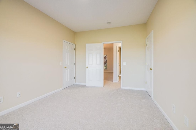 unfurnished bedroom featuring light colored carpet