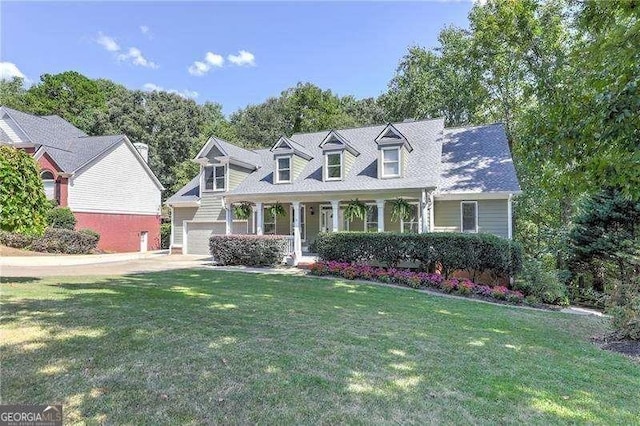 cape cod-style house with covered porch and a front lawn