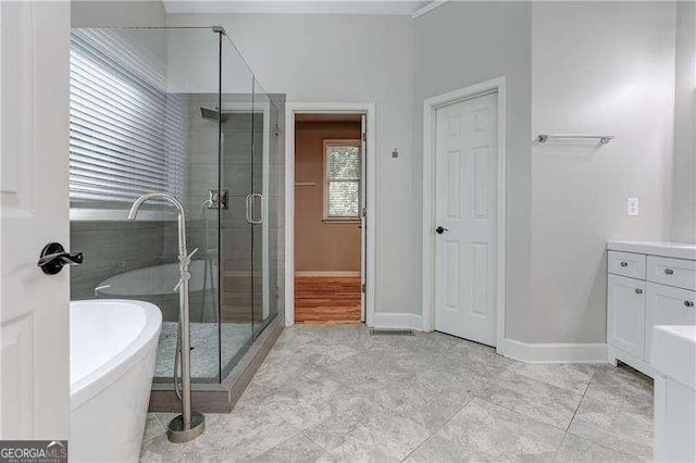 bathroom with separate shower and tub and vanity