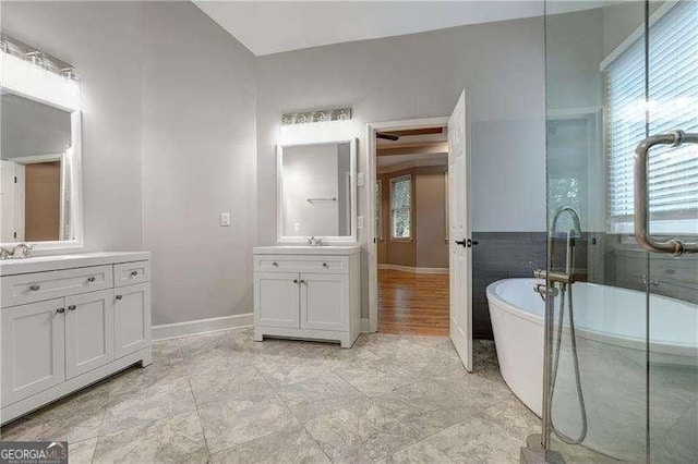 bathroom with a tub to relax in and vanity