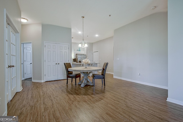 dining area with an inviting chandelier and hardwood / wood-style floors