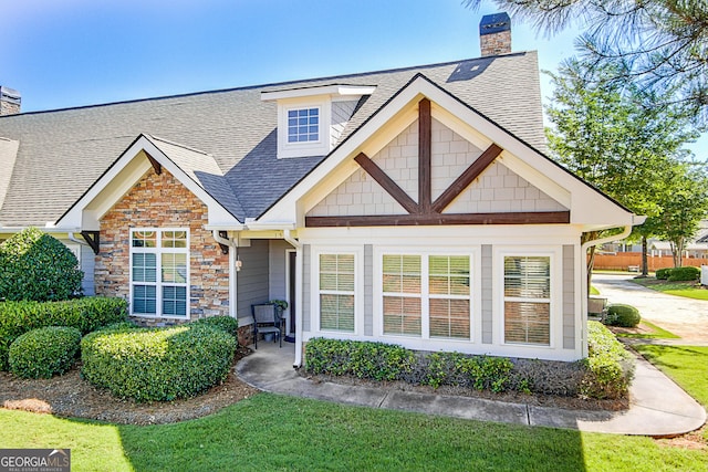 rear view of house featuring a lawn