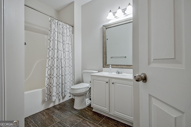 full bathroom with toilet, vanity, and shower / tub combo