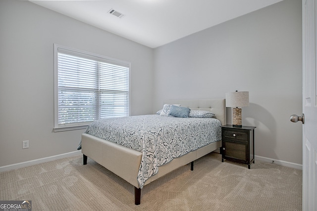 bedroom with light colored carpet