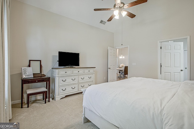 carpeted bedroom featuring ceiling fan and high vaulted ceiling