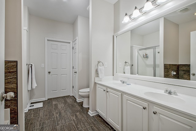 bathroom featuring an enclosed shower, vanity, and toilet