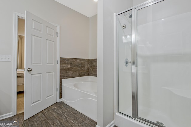 bathroom featuring independent shower and bath