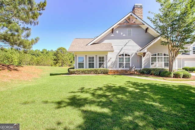 rear view of property featuring a yard