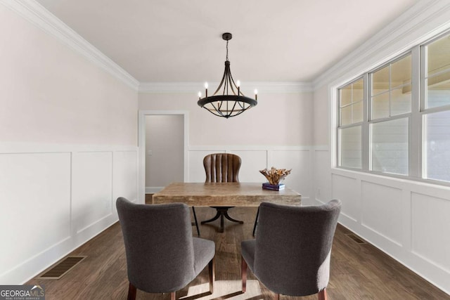 5721 Brickhampton Ct, Clermont, GA 30527 - dining area featuring a chandelier, a decorative wall, crown molding, wainscoting, and dark wood-style floors