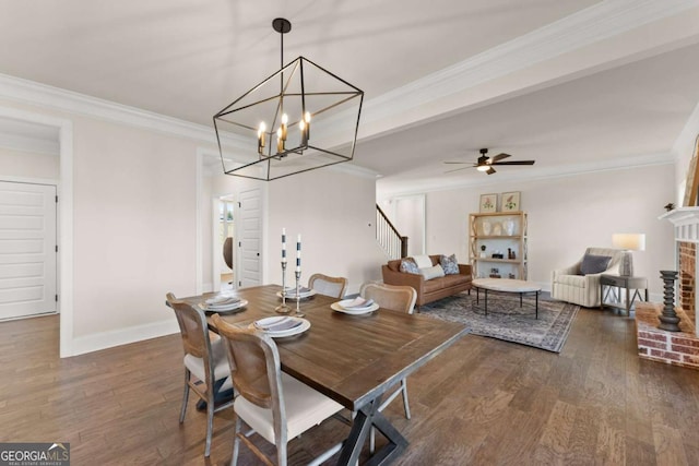 5721 Brickhampton Ct, Clermont, GA 30527 - dining area featuring dark wood-type flooring, crown molding, a chandelier, a ceiling fan, and baseboards