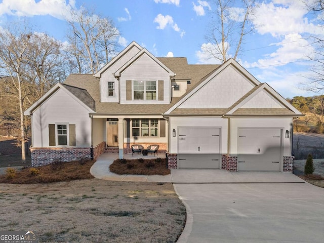5721 Brickhampton Ct, Clermont, GA 30527 - view of front facade with brick siding, driveway, covered porch, a garage, and a shingled roof