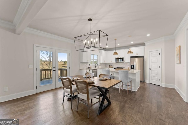 dining space with sink, an inviting chandelier, ornamental molding, french doors, and dark hardwood / wood-style flooring