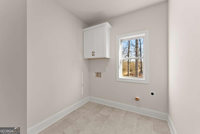 clothes washing area with cabinets and electric dryer hookup