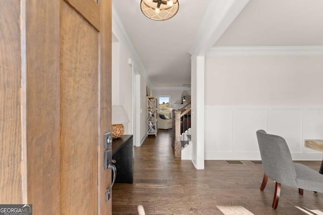 5721 Brickhampton Ct, Clermont, GA 30527 - entryway with crown molding, dark wood-style floors, a wainscoted wall, a decorative wall, and stairs