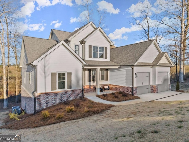 view of front of property featuring a porch and a garage