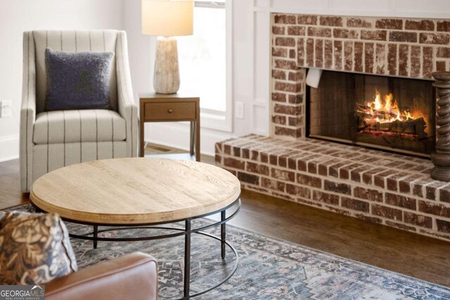 5721 Brickhampton Ct, Clermont, GA 30527 - sitting room with wood finished floors and a fireplace
