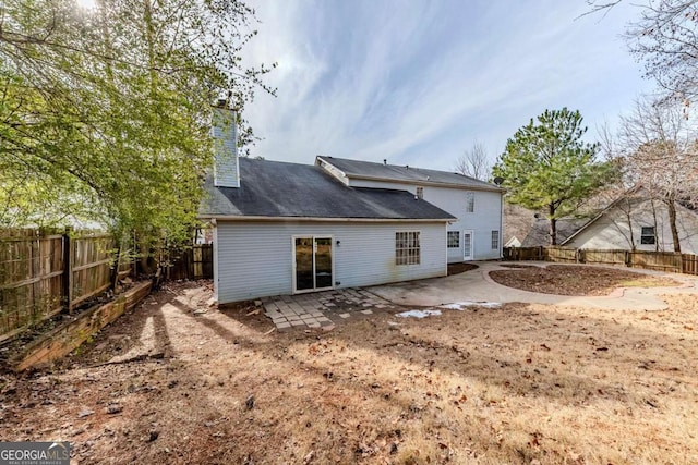 rear view of property featuring a patio area