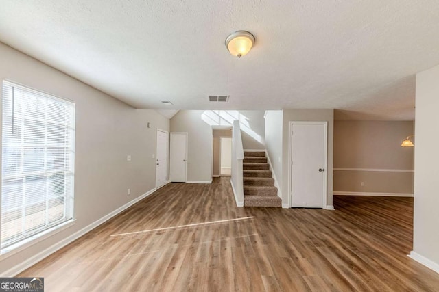 interior space with wood-type flooring and a wealth of natural light