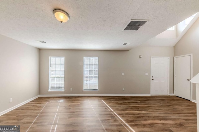 empty room with dark hardwood / wood-style flooring