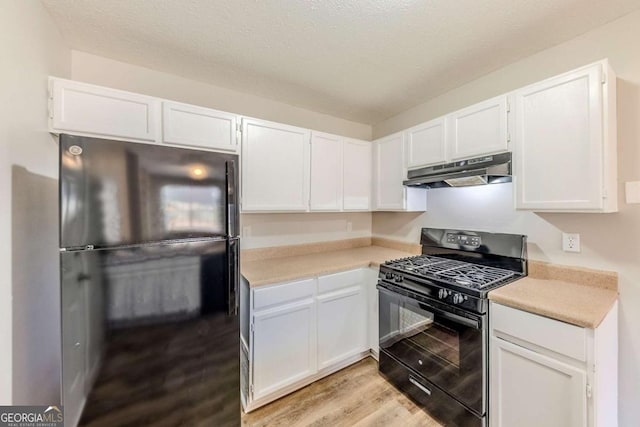 kitchen with black appliances, a textured ceiling, white cabinetry, and light hardwood / wood-style flooring