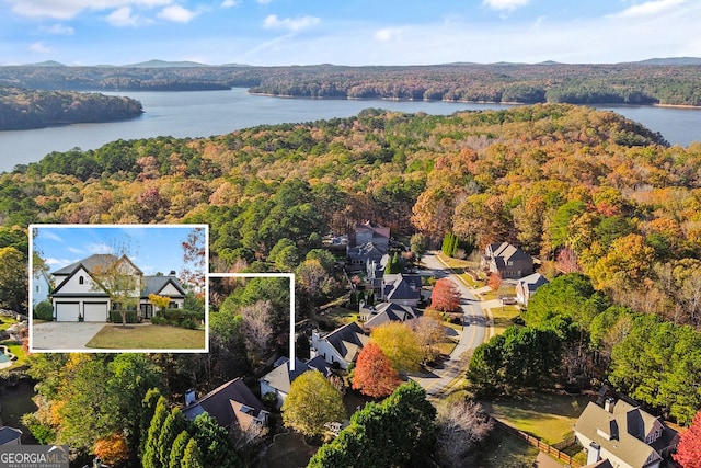 birds eye view of property with a water view