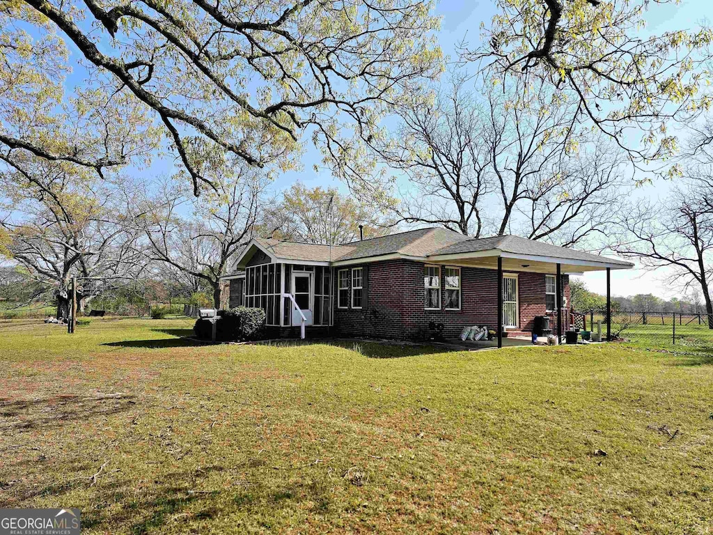 exterior space with a front yard and a sunroom