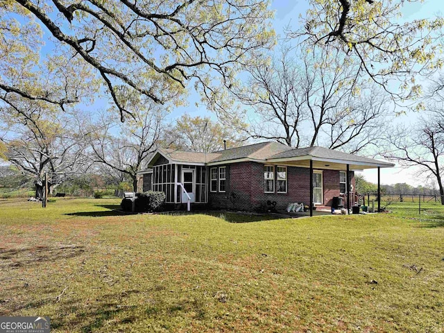 exterior space with a front yard and a sunroom