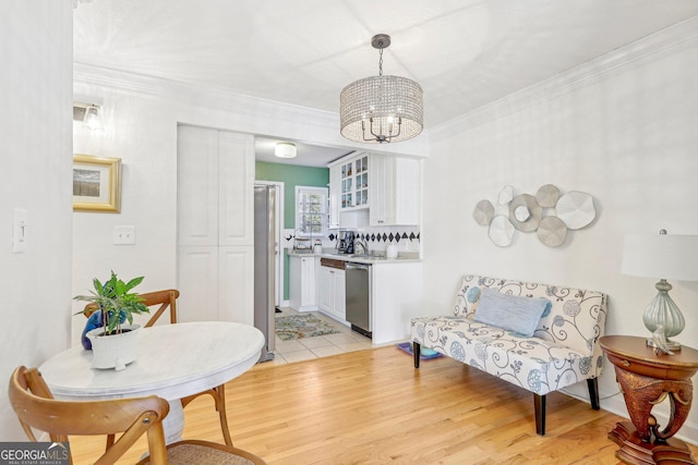 885 Briarcliff Rd NE Unit 21, Atlanta, GA 30306 - dining room with a chandelier, light wood-type flooring, and ornamental molding