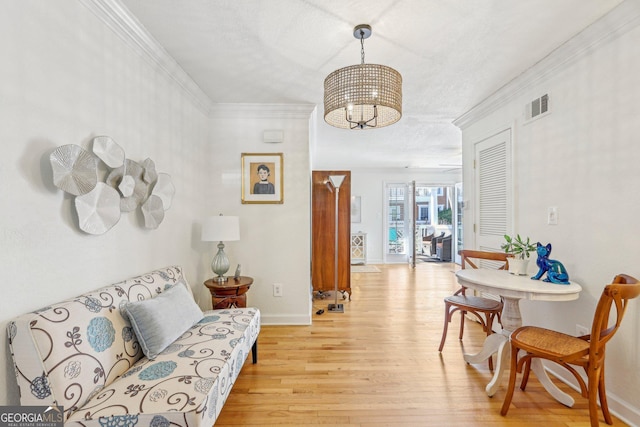 885 Briarcliff Rd NE Unit 21, Atlanta, GA 30306 - living area with a chandelier, light wood-style floors, baseboards, and ornamental molding