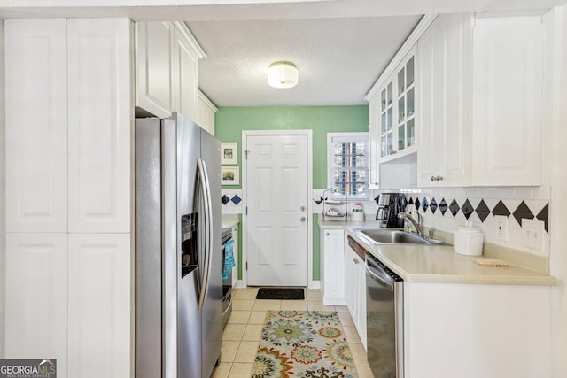 885 Briarcliff Rd NE Unit 21, Atlanta, GA 30306 - kitchen featuring a sink, stainless steel appliances, light countertops, white cabinets, and a textured ceiling