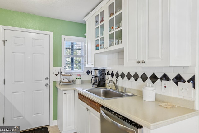 885 Briarcliff Rd NE Unit 21, Atlanta, GA 30306 - kitchen featuring a sink, stainless steel dishwasher, tasteful backsplash, and glass insert cabinets