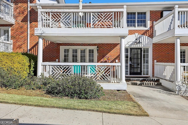 885 Briarcliff Rd NE Unit 21, Atlanta, GA 30306 - back of house with a balcony, brick siding, and a porch