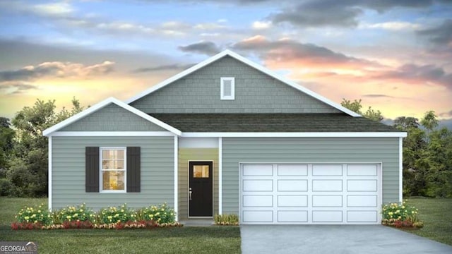 view of front of home featuring a garage and a lawn