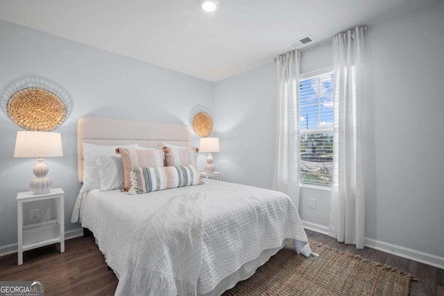 bedroom with dark hardwood / wood-style flooring