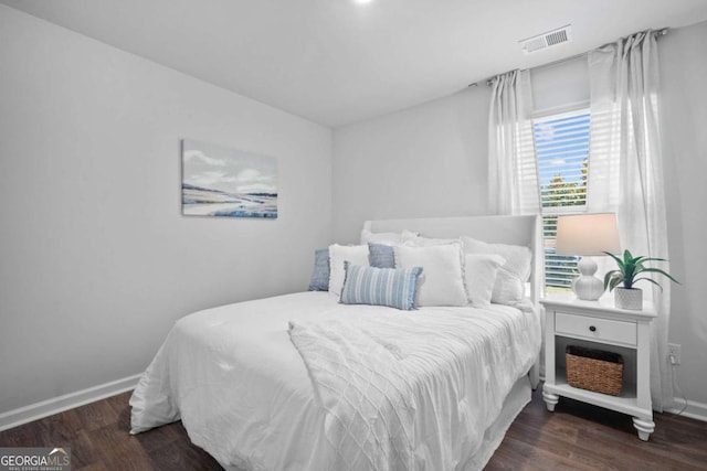 bedroom with dark wood-type flooring