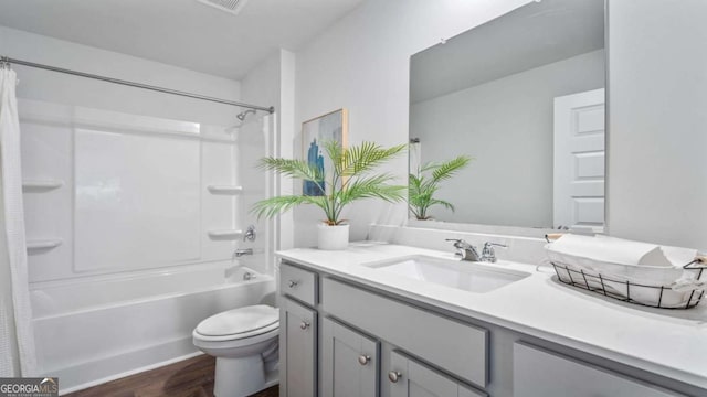 full bathroom featuring toilet, shower / bath combination with curtain, hardwood / wood-style flooring, and vanity