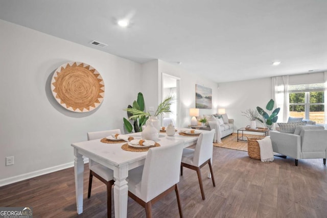 dining space with dark hardwood / wood-style floors