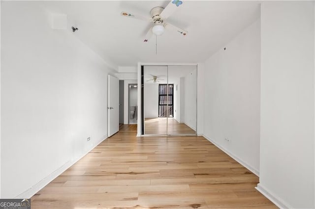 unfurnished room with ceiling fan and light wood-style floors