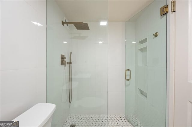 bathroom with a stall shower and toilet