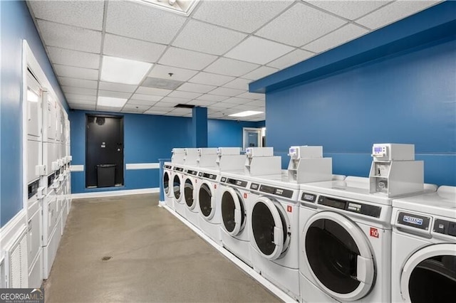 community laundry room featuring stacked washer / drying machine and washing machine and dryer