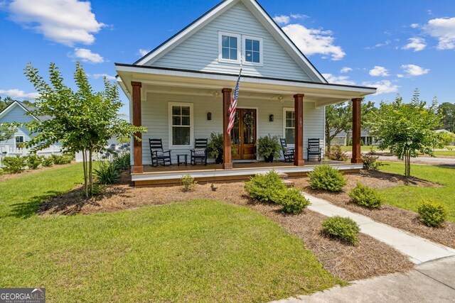 bungalow-style house with a front yard and a porch