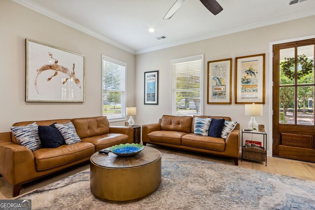 living room with ceiling fan, a wealth of natural light, crown molding, and hardwood / wood-style floors