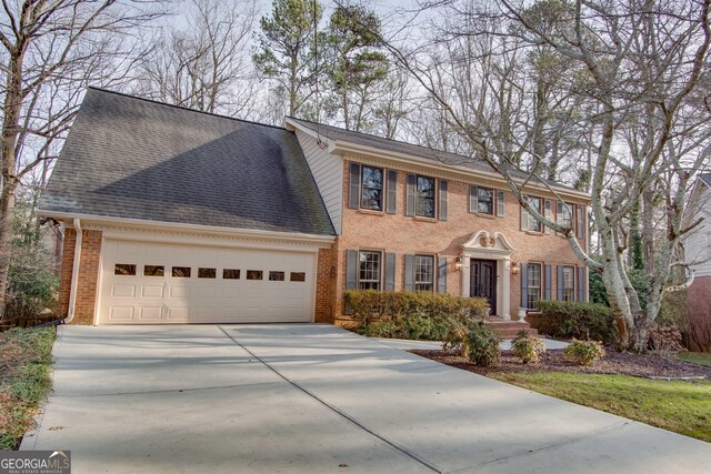 view of front of property featuring a garage and a front yard