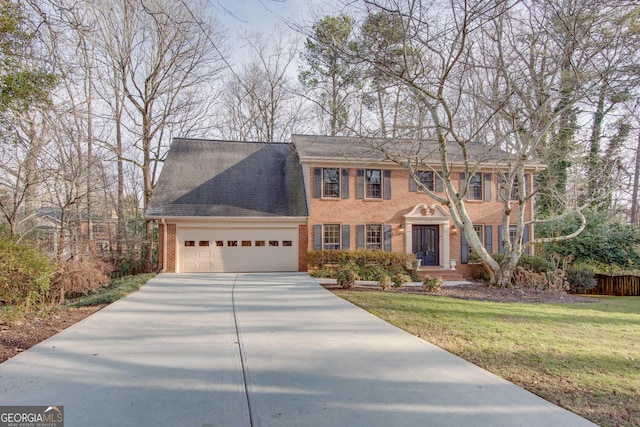 view of front facade with a garage and a front yard