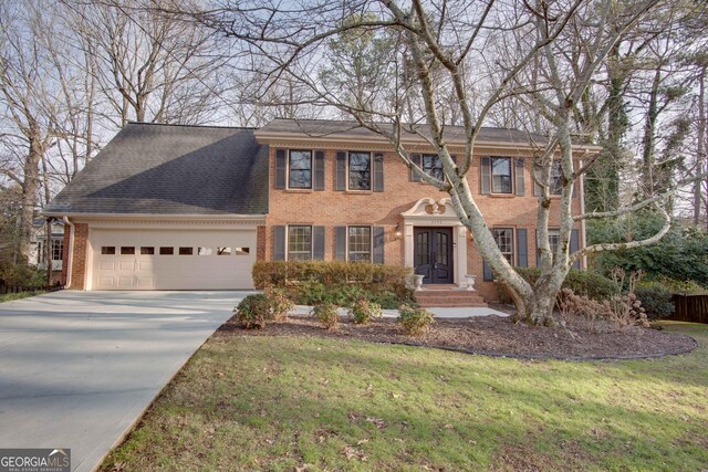 view of front facade with a front yard and a garage