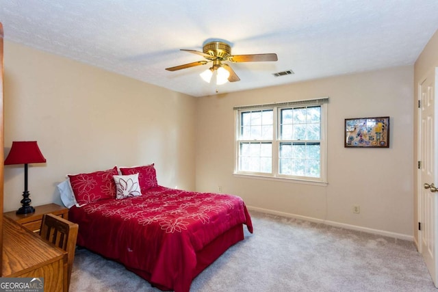 bedroom featuring ceiling fan and carpet