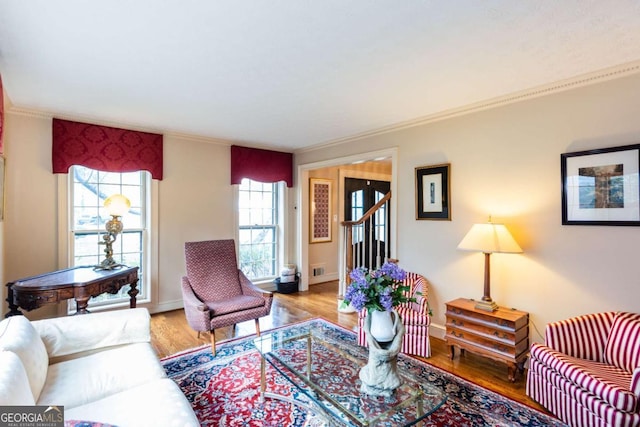 living room with a wealth of natural light and light hardwood / wood-style flooring