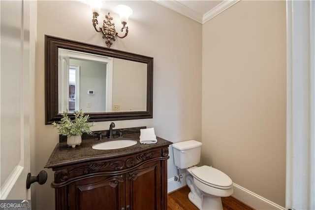 bathroom with hardwood / wood-style flooring, vanity, crown molding, and toilet